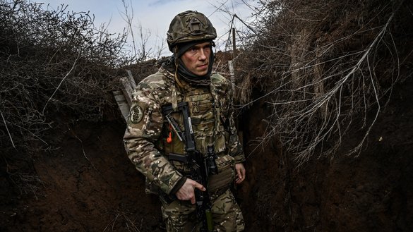 Ukrainian troops patrol at the frontline outside the town of Novoluhanske, eastern Ukraine, on February 19. Ukraine's army that day said that two of its soldiers died in attacks on the frontline with Russian-backed separatists, the first fatalities in the conflict in more than a month. [Aris Messinis/AFP]