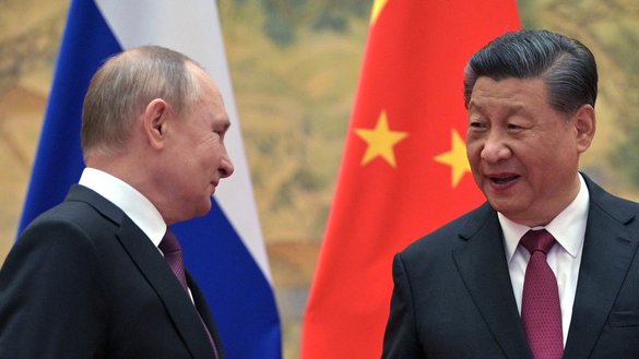 Russian President Vladimir Putin and Chinese President Xi Jinping arrive to pose for a photograph during their meeting in Beijing, on February 4. [Alexei Druzhinin / Sputnik / AFP]