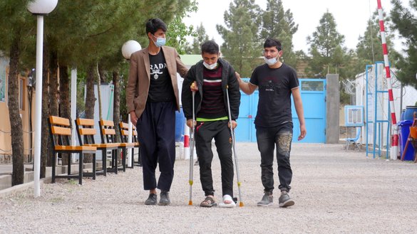 Naqibullah Ghafoory, 23, a resident of Takhar, walks at a UN refugee camp in Herat city on April 10, days after Iranian authorities broke his leg while he was in Tehran. [Omar/Salaam Times]