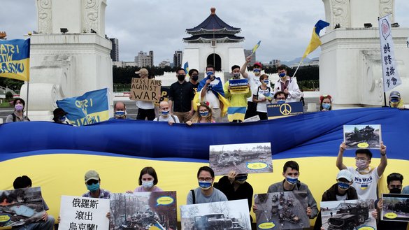 Slavs and other residents of Taiwan display posters and a Ukraine flag during a rally in Taipei on May 8. [Sam Yeh/AFP]