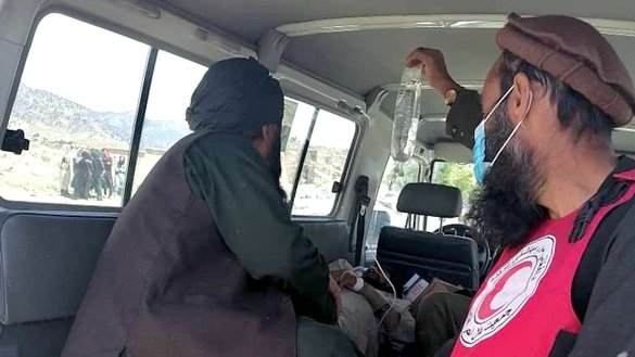 Red Cross personnel June 22 in Khost province help Afghans injured by the earthquake. [IFRC]