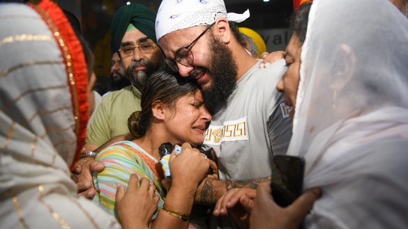 Members of the Afghan Sikh community react upon arriving from Afghanistan in New Delhi, India, on June 30, following the June 18 attack by gunmen at a Sikh temple in Kabul that killed a Sikh man. [AFP]