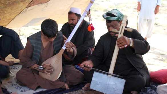 In this photograph taken on December 2, 2020, in Sheberghan, capital of Jawzjan province, members of the Jogi community play local musical instruments. [Atiqullah Ibrahimzada]