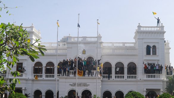 Thousands of anti-government protesters stormed into Sri Lankan Prime Minister Ranil Wickremesinghe's office on July 13, hours after he was named as acting president. [AFP]