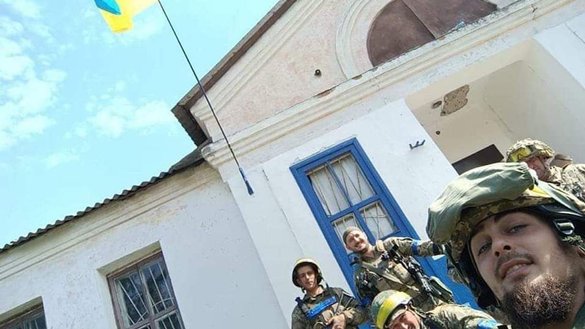 Ukrainian troops take a selfie with a Ukrainian flag after liberating a town in Kharkiv province from Russian forces in this photo posted on September 10. [Ukrainian General Staff/Twitter]
