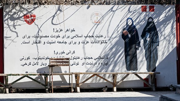 A banner ordering women to cover themselves with a hijab is pictured at a private university after the universities were reopened in Kabul on March 6. [Wakil Kohsar/AFP]