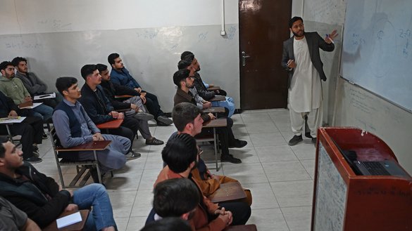 Male students attend their computer science class after the universities were reopened in Kabul on March 6. [Wakil Kohsar/AFP]