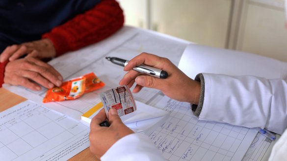 A midwife gives prescription drugs to a female patient at one of the newly built health centres in Samagan province in this undated photo. [UNFPA]