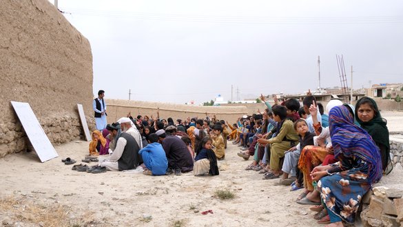 Girls and boys and even some elders attend lessons outside, under the sweltering sun or exposed to the rain. [Hamza]