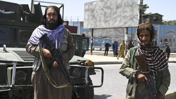 Afghan security personnel stand guard last July in Kabul. [Wakil Kohsar / AFP]
