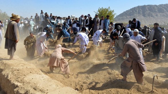 Men bury the victims of an ISIS-K attack on October 16, 2021, a day after 41 people were killed in a suicide attack claimed by the extremist group in a Kandahar mosque. [Javed Tanveer/AFP]