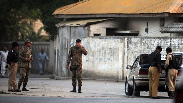 Pakistani soldiers and police officials keep vigil near the hideout of al-Qaeda founder Osama bin Laden after US Special Forces killed him in a ground operation in Abbottabad on May 2, 2011. [Aamir Qureshi/AFP]