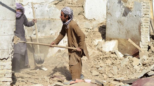 Afghan workers remove the rubble of a suspected ISIS-K hideout in Kandahar, November 2021. [Javed Tanveer/AFP]