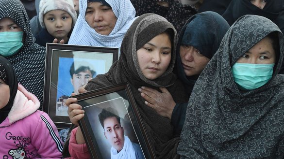 Members of Pakistan's Hazara community protest in Quetta on January 6, 2021, displaying photographs of coal miners killed in an ISIS-K attack in Machh. [Banaras Khan/AFP]