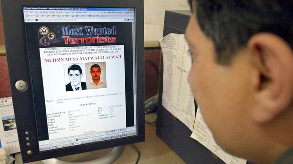 A journalist views an image of al-Qaeda bomb maker Muhsin Musa Matwalli Atwah in Islamabad on April 13, 2006, a day after Atwah died in a strike near the Afghan border. [Farooq Naeem/AFP]