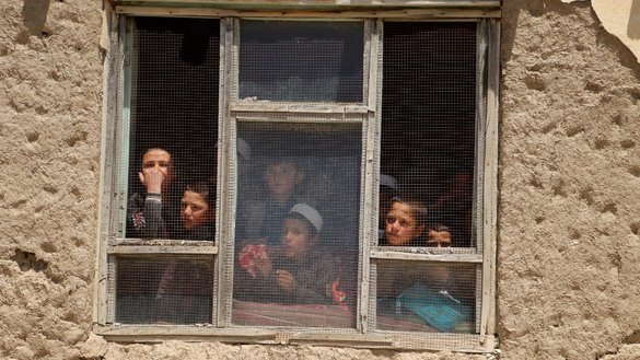 Students look out from the window of a madrassa in Badakhshan province's Argo district on May 10, 2023. [Omer Abrar/AFP]