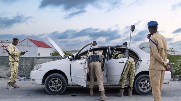 Officers of Somalia's security agencies conduct vehicle and passenger checks at a checkpoint on the outskirts of Mogadishu, on November 10, 2025. Mogadishu is rising, literally, from the ashes of decades of war. [TONY KARUMBA / AFP]