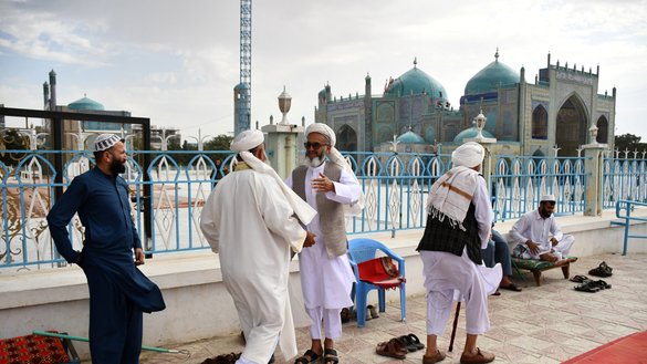 Afghan Muslims greet each other after Eid al-Adha prayers at the Shrine of Hazrat Ali, also known as the Blue Mosque, in Mazar-i-Sharif on June 17, 2024. [Atif Aryan/AFP]