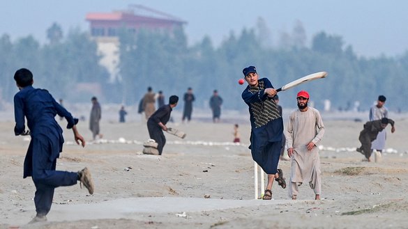 Afghan boys play cricket at a field in Jalalabad on October 28, 2025. [Wakil KOHSAR/AFP]